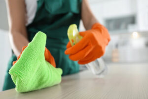 A cleaning professional from Martha the cleaning lady wiping a kitchen countertop in Chicago, IL