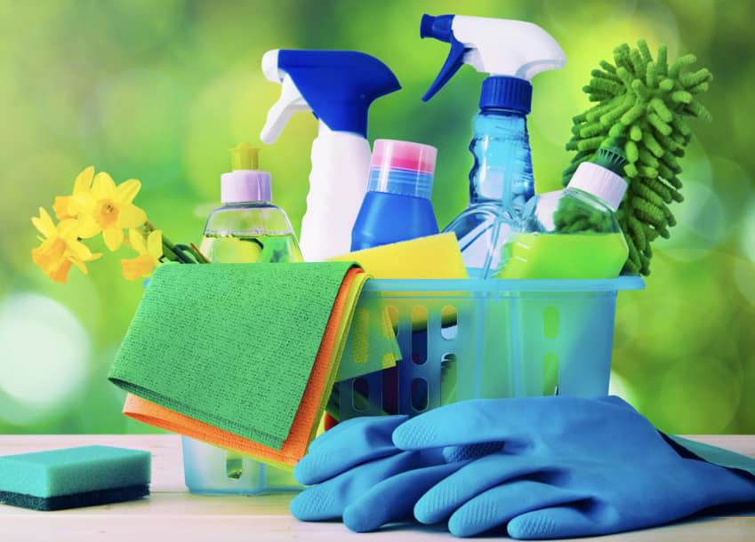 A basket filled with various cleaning supplies, including spray bottles, cloths, and gloves, for A Perfect Clean in Wichita, KS.