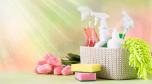 A basket of cleaning supplies including spray bottles, sponges, and a cloth for The Cleaning Bee in Atlanta, GA.