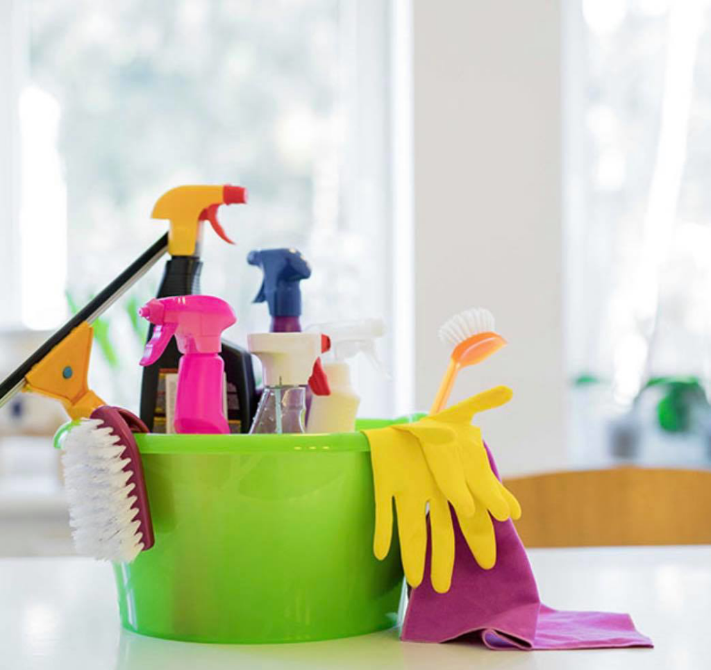 A green bucket filled with various cleaning supplies for Ariana cleaning services in Fort Lauderdale, FL