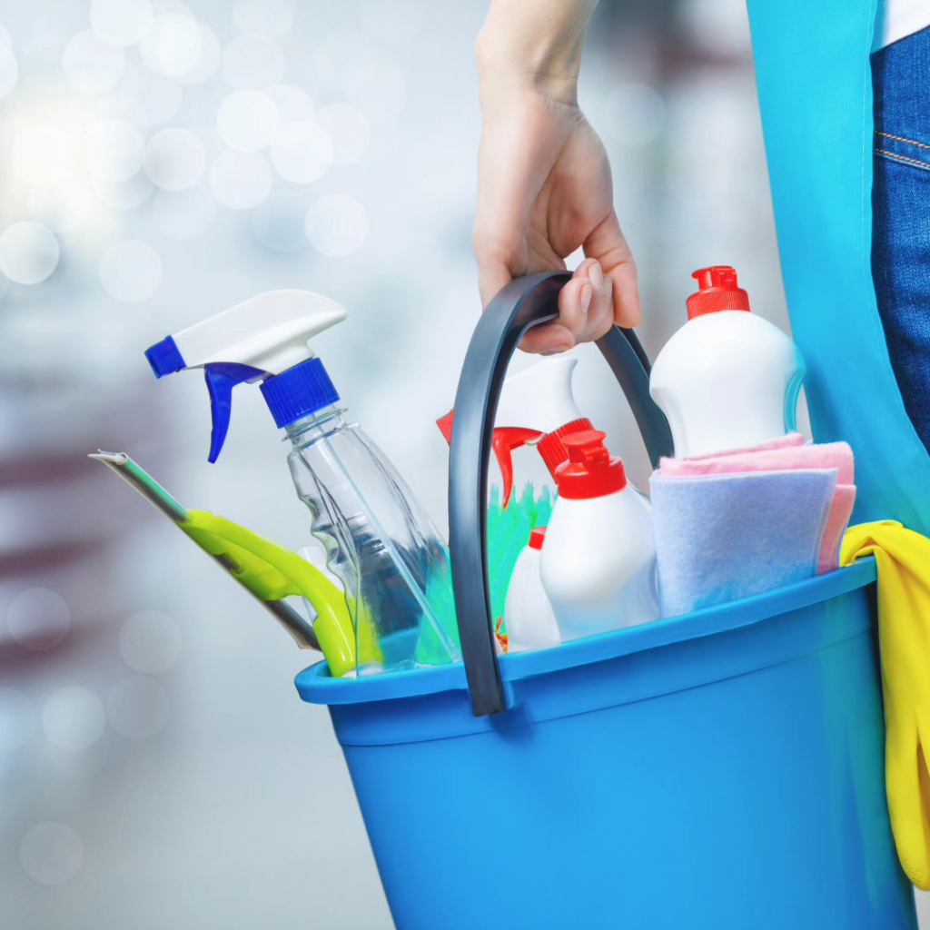A blue bucket filled with various cleaning supplies, ready for use by Jessica's sparkling services in Pekin, IL