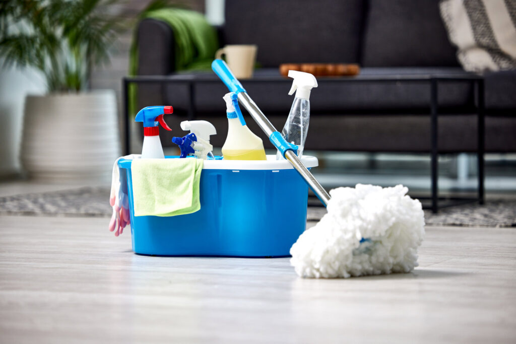 A bucket filled with cleaning supplies and a mop ready for house cleaning by Harsh's Cleaning Services LLC in Canton, OH.