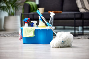 A bucket filled with cleaning supplies and a mop ready for house cleaning by Harsh's Cleaning Services LLC in Canton, OH.
