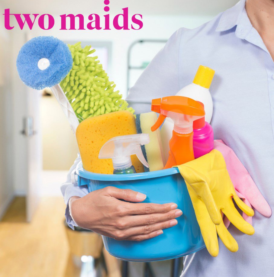 A person holding a blue bucket filled with various cleaning supplies for Two Maids of Hilton Head, SC.