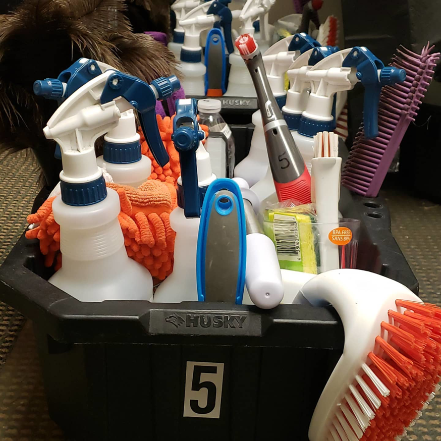 A caddy filled with various cleaning supplies and tools for Nooks and Crannies Cleaning Services in Norfolk, VA.