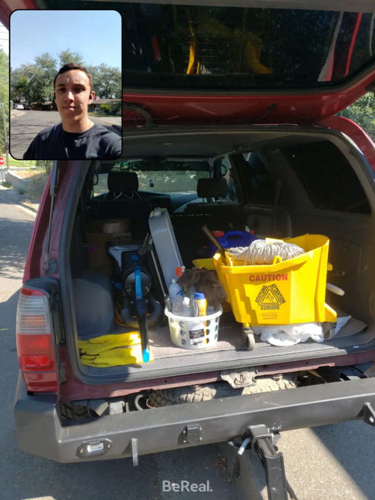 Various cleaning supplies and equipment, including a mop bucket and vacuum, loaded in an SUV for Gavin's Cutting Edge in Moscow, ID.