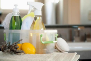 A caddy filled with natural cleaning supplies, lemons, and lavender, ready for use by Karis Klean in Auburn, AL