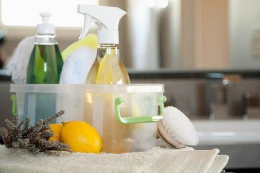 A caddy filled with natural cleaning supplies, lemons, and lavender, ready for use by Karis Klean in Auburn, AL