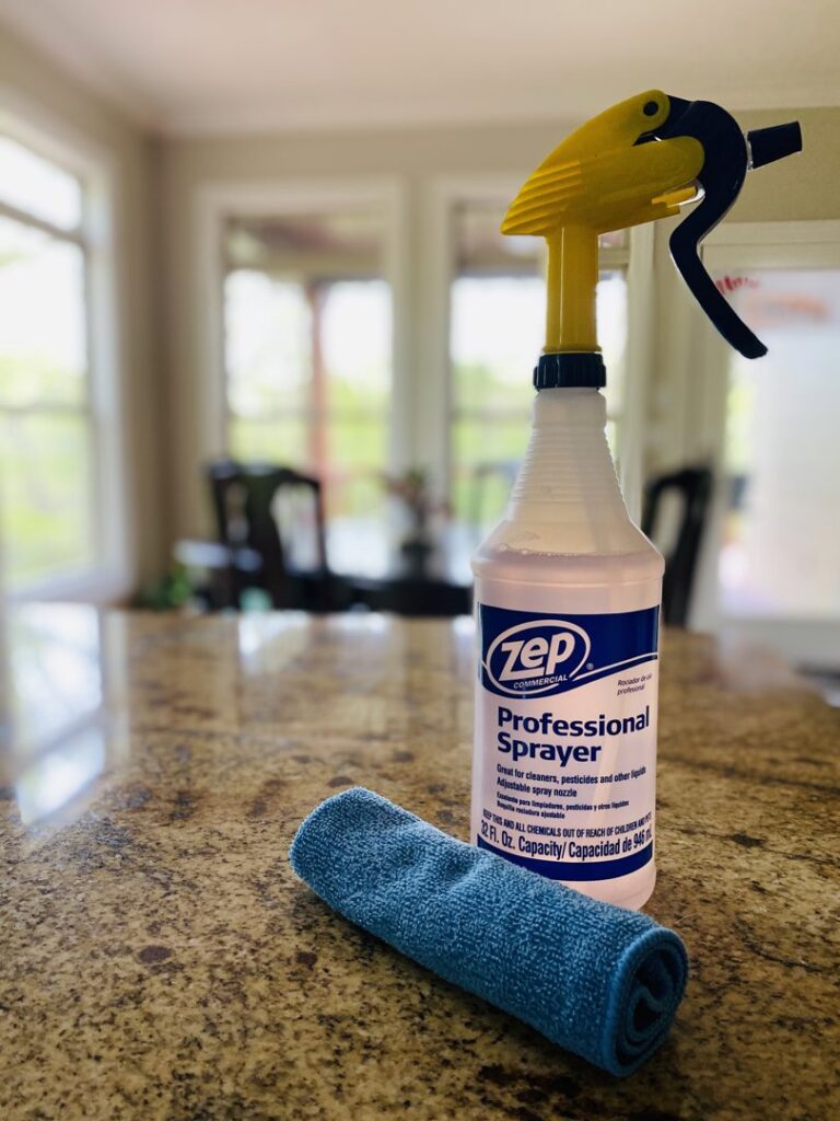 Professional cleaning supplies, including a spray bottle and microfiber cloth, used by Sudz Up Cleaning Company in Columbia, MO.