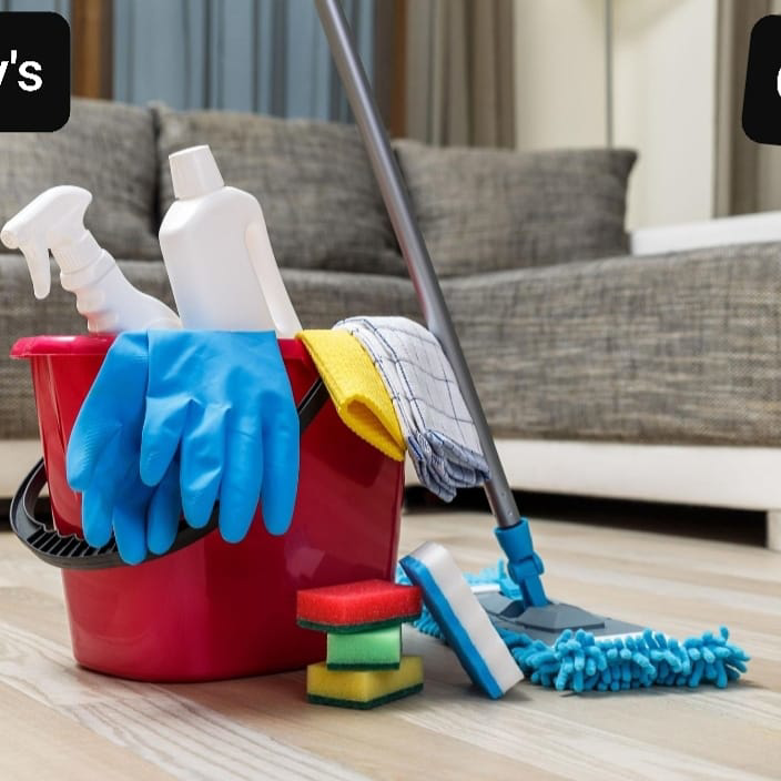 A red bucket with cleaning supplies and a mop on a wooden floor, ready for a house cleaning job by Jimmy's Cleaning Services in Woodruff, SC.
