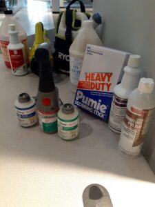 Various cleaning supplies and products laid out, used by Janice Janitorial LLC for professional cleaning in Baton Rouge, LA.