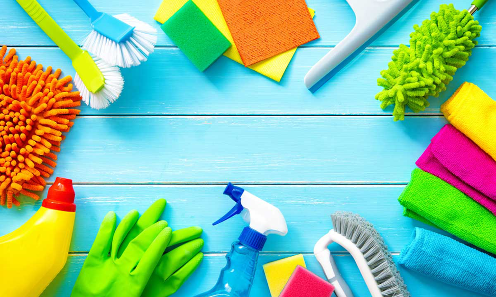 A flat lay of various cleaning supplies, including brushes, sponges, and spray bottles, for Speedy Rabbit Cleaning in North Las Vegas, NV.