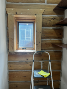 A step ladder with a yellow cleaning cloth next to a window, indicating cleaning by Clean & Clear Pros LLC in Timm Place, USA.