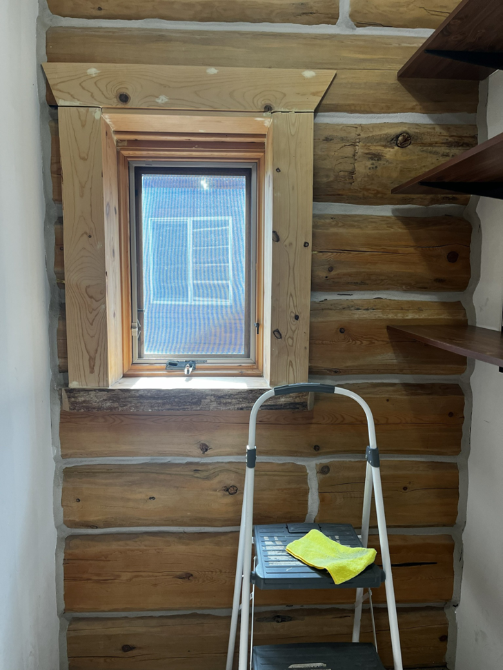 A step ladder with a yellow cleaning cloth next to a window, indicating cleaning by Clean & Clear Pros LLC in Timm Place, USA.