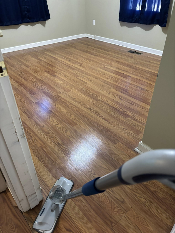 A mop cleaning a wooden floor in a room, showcasing services by Nova's Home Cleaning Services in Roanoke, VA.