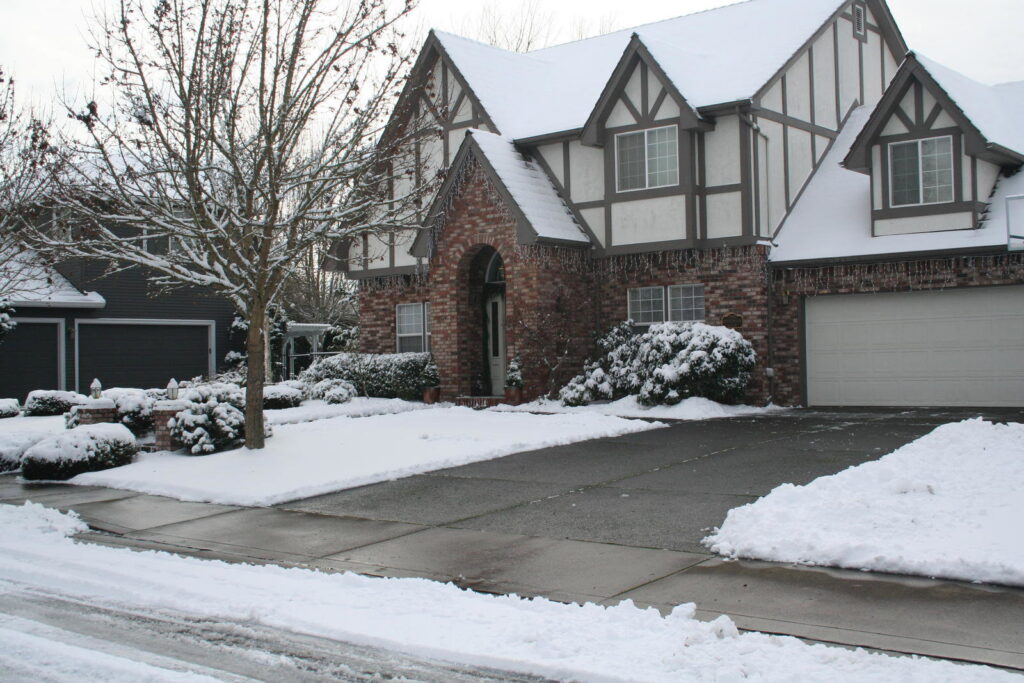 A residential driveway and sidewalk clearly cleared of snow by Snow Doctors in Sioux City, IA