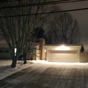 A residential driveway and sidewalk cleared of snow by Akron Lawn Care And Snow Removal in Akron, OH.