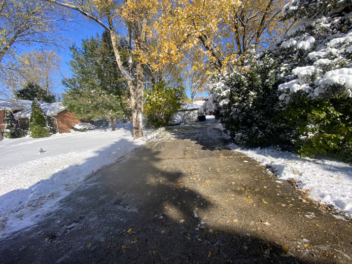 A residential driveway partially cleared of snow by Evo Lawn & Landscape LLC in Waukegan, IL.