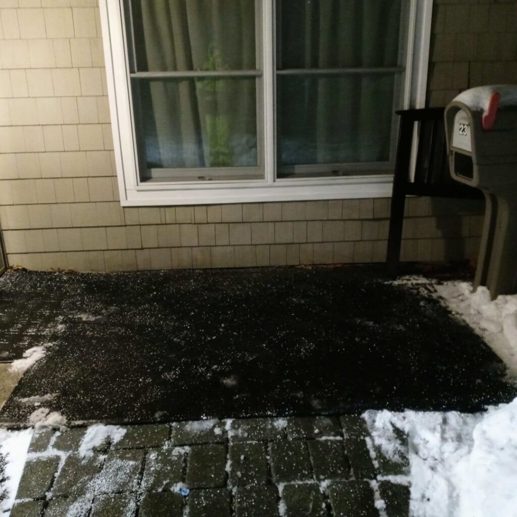 A front porch and walkway cleared of snow with ice melt visible, provided by JG Lawn Care and Snow Removal, LLC in Albany, GA.