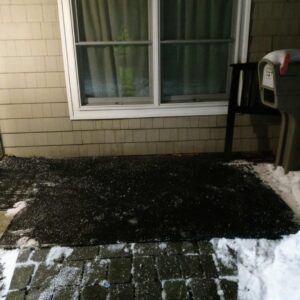 A front porch and walkway cleared of snow with ice melt visible, provided by JG Lawn Care and Snow Removal, LLC in Albany, GA.