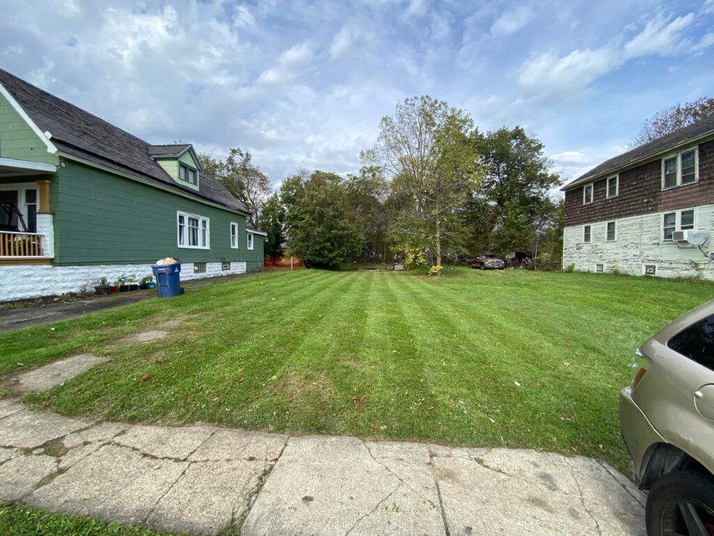 A cleared path through deep snow at a residential property by Rose Landscaping and Snow Removal in Buffalo, NY.