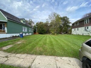 A cleared path through deep snow at a residential property by Rose Landscaping and Snow Removal in Buffalo, NY.