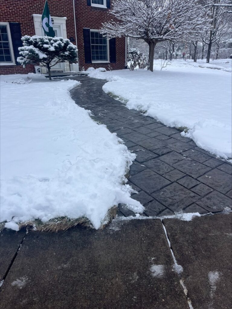 A cleared pathway after snow removal service by Snow Scholars - Snow Removal By College Students in Madison, WI.