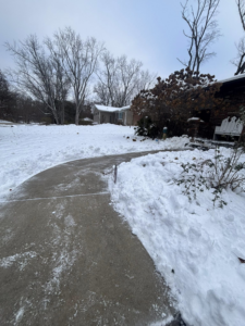 A residential sidewalk and path cleared of snow by Jmccllm landscaping lawn care, junk removal in Springfield, IL.