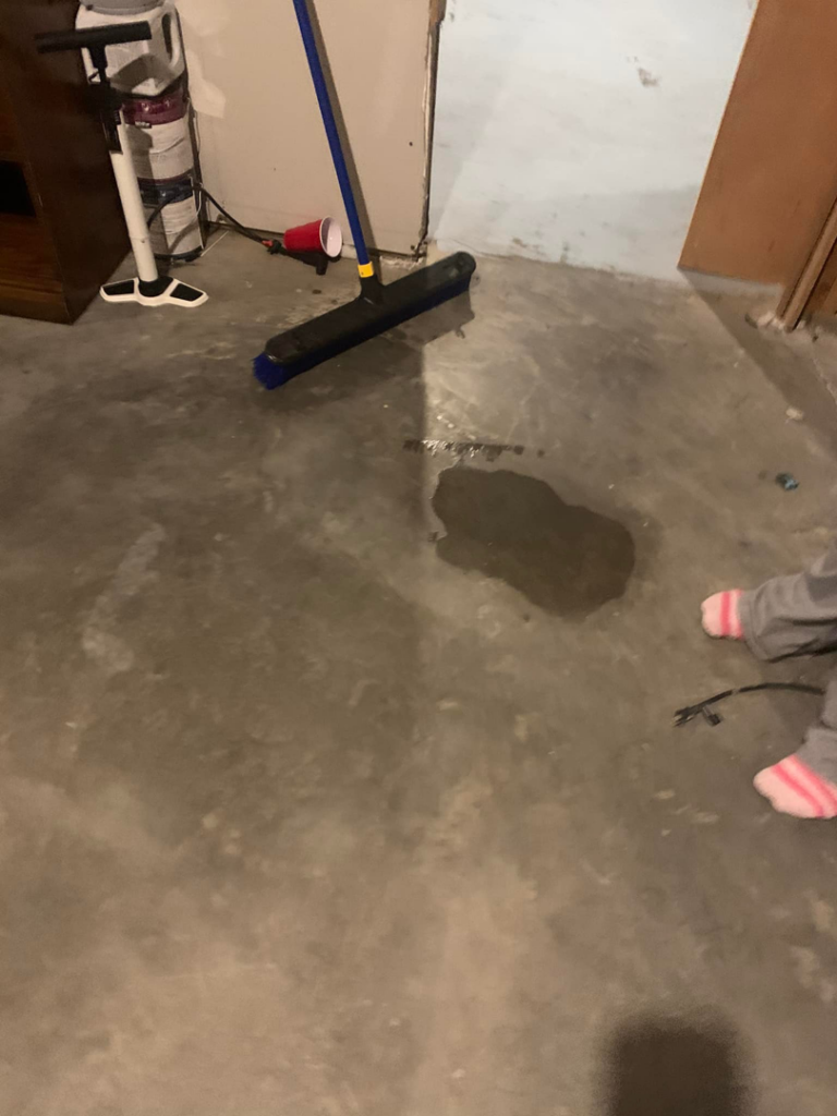 A close-up of a Tramex moisture meter on a floor, detecting water damage for H&H2o Response & Restoration in Janesville, WI