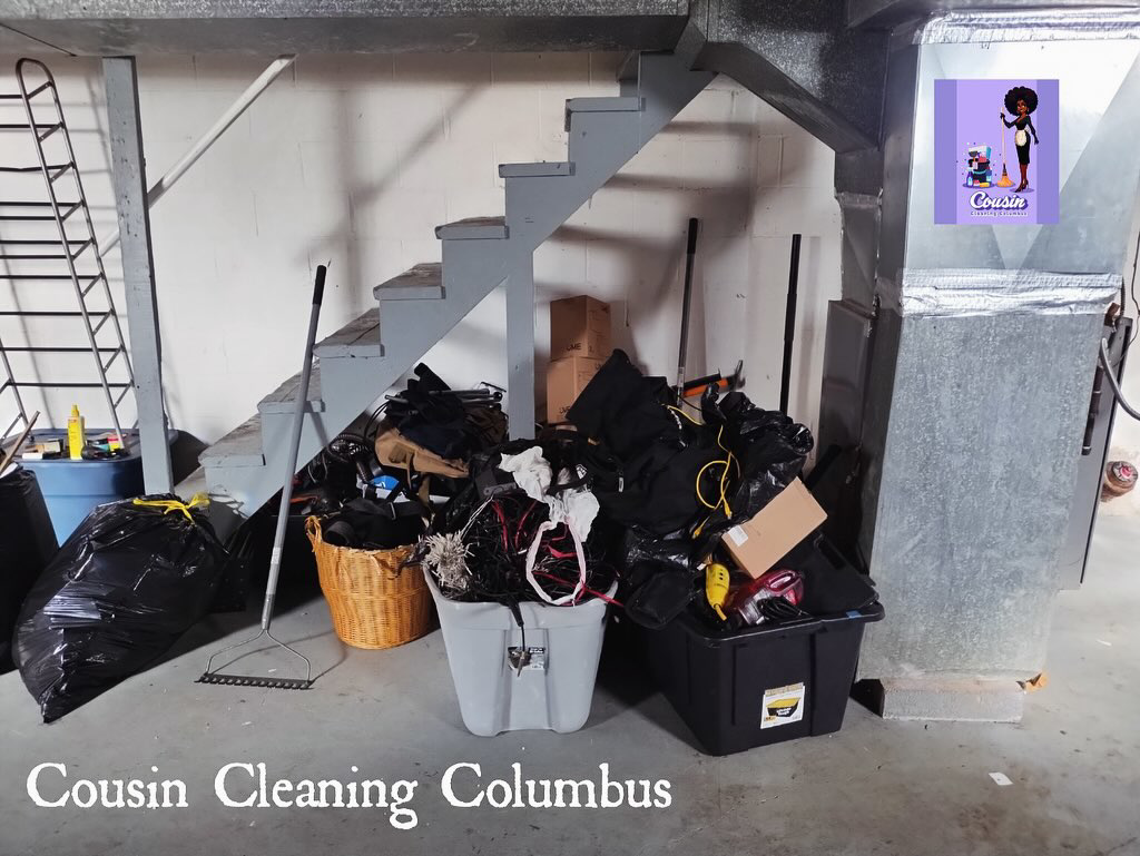 A cluttered basement corner with trash bags and bins, showing a space ready for cleaning by Cousin Cleaning Columbus, OH.