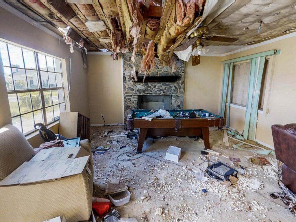 A room with a collapsed ceiling and debris on the floor due to severe water damage, handled by A1 Restoration of Spokane in Post Falls, ID.