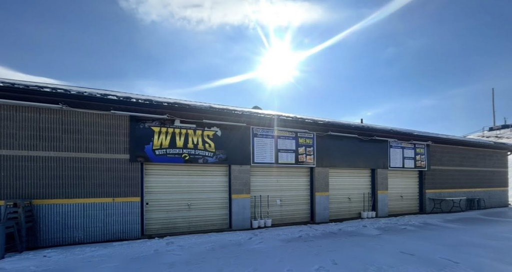 Commercial building with beige roll-up garage doors in winter, installed by Overhead Door Company of Mid-Ohio Valley in Parkersburg, WV.