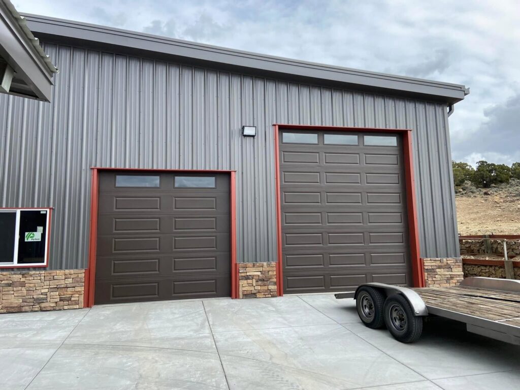 Two brown commercial sectional garage doors installed on a building by The Door Man - Garage Doors & Openers in Reno, NV