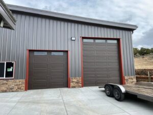 Two brown commercial sectional garage doors installed on a building by The Door Man - Garage Doors & Openers in Reno, NV