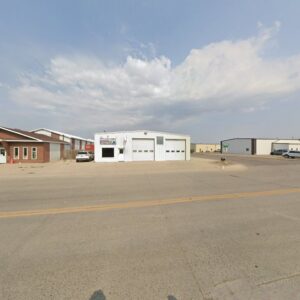 A commercial building featuring multiple garage doors, serviced by PS Garage Doors of Williston, ND.