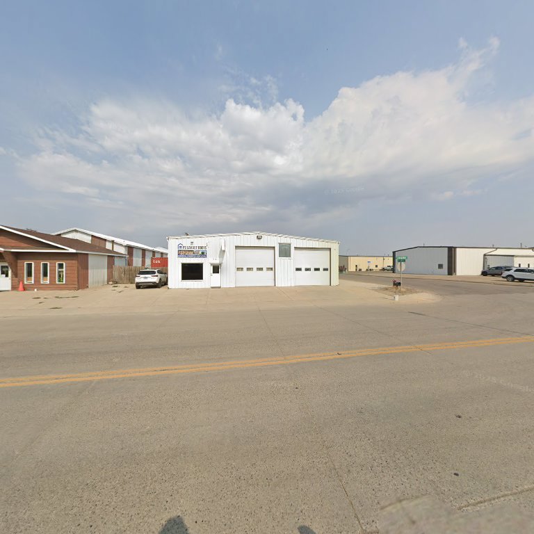 A commercial building featuring multiple garage doors, serviced by PS Garage Doors of Williston, ND.