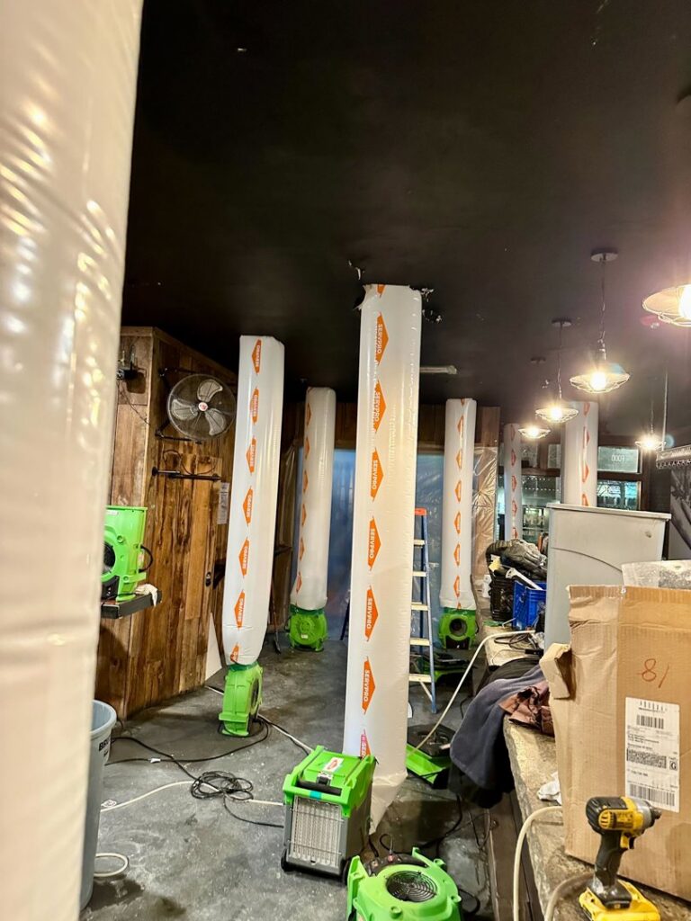 Multiple air movers and drying equipment set up in a commercial space for water damage restoration by Servpro of Sandy in Sandy, UT.