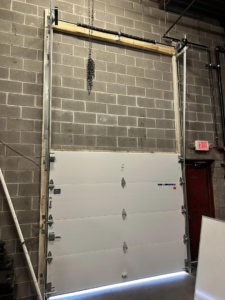Commercial garage door installation in progress by Above All Garage Doors in Kansas City, KS.