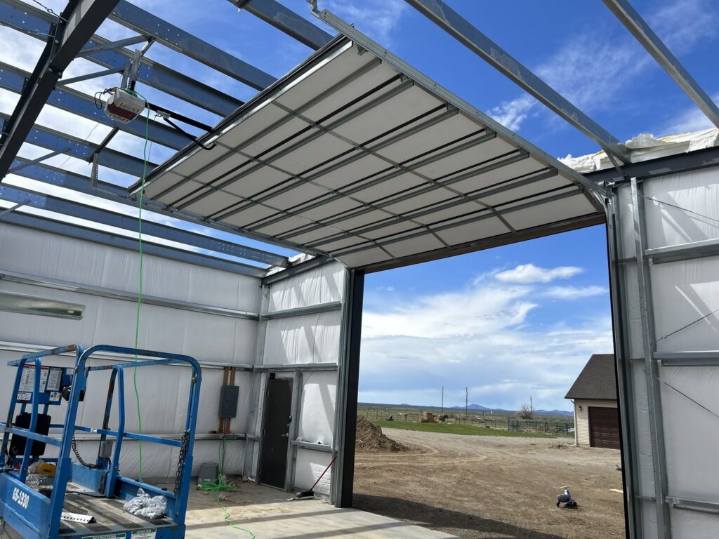 Commercial garage door installation in progress, showing the track system and opener by Barrett Overhead Doors in Idaho Falls, ID.