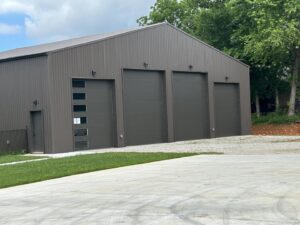 Multiple dark gray commercial garage doors, including one with windows, installed by Coney's Garage Doors in Conway, AR.