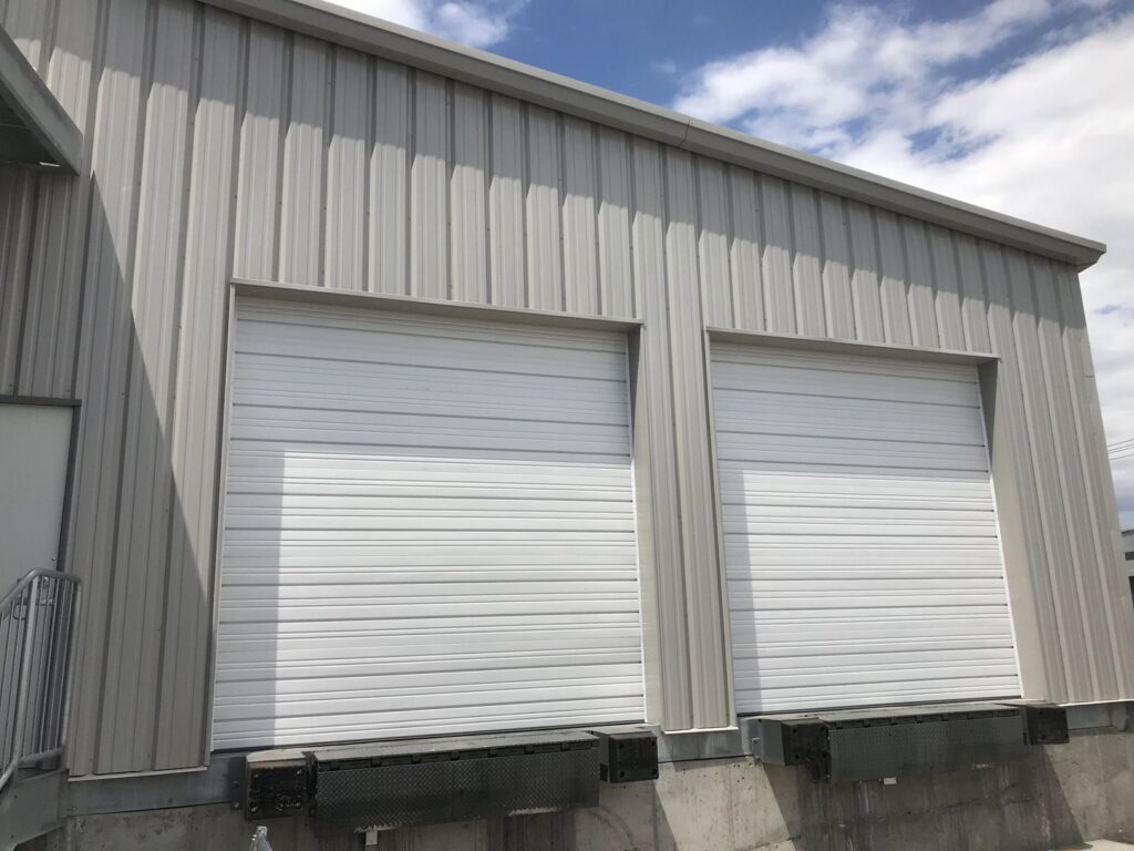 Two commercial loading dock garage doors installed by Up N Over Garage Doors LLC in Layton, UT.
