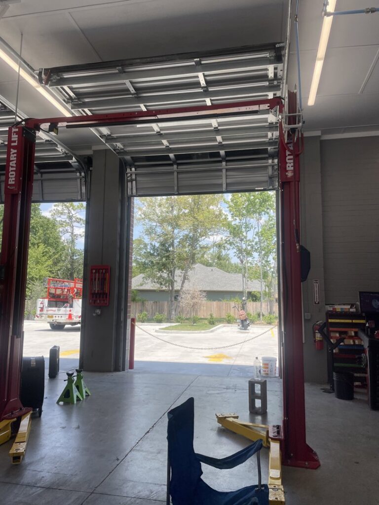 Interior view of a commercial overhead garage door and lift, serviced by Jonathan at Verge Entrance Solutions/Overhead Door in Hattiesburg, MS.
