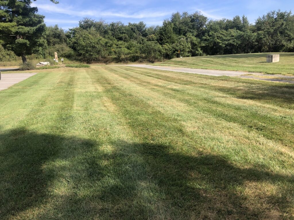A commercial property's expansive lawn with precise mowing stripes, maintained by Neace's Lawn Care LLC in Martinsburg, WV.