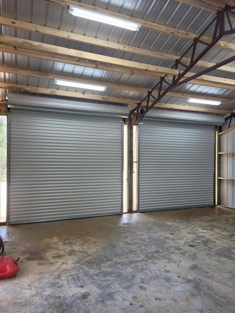 Two newly installed commercial roll-up garage doors in a large building, completed by Lifetime Garage Door in Las Vegas, NV.