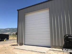 Exterior view of a commercial roll-up garage door installed by Up N Over Garage Doors LLC in Layton, UT.