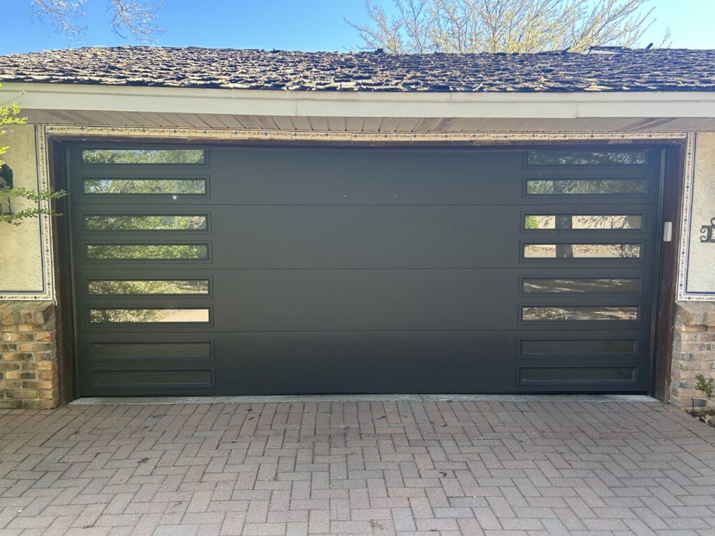 Two dark gray rolling steel doors installed on a commercial building by Wayne Dalton Sales & Service of Albuquerque, NM
