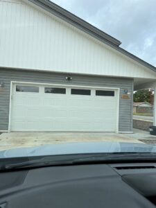 Two commercial sectional garage doors with windows installed by Fayetteville Garage Door Co. in Fayetteville, AR