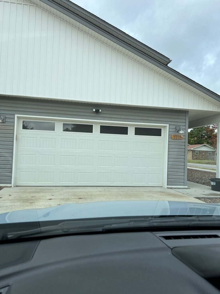 Two commercial sectional garage doors with windows installed by Fayetteville Garage Door Co. in Fayetteville, AR