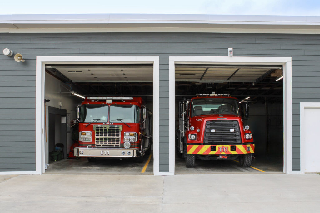 A commercial building, a fire station, featuring durable gray horizontal siding installed by Xtreme Exteriors in Rogers, AR.
