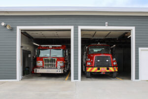 A commercial building, a fire station, featuring durable gray horizontal siding installed by Xtreme Exteriors in Rogers, AR.